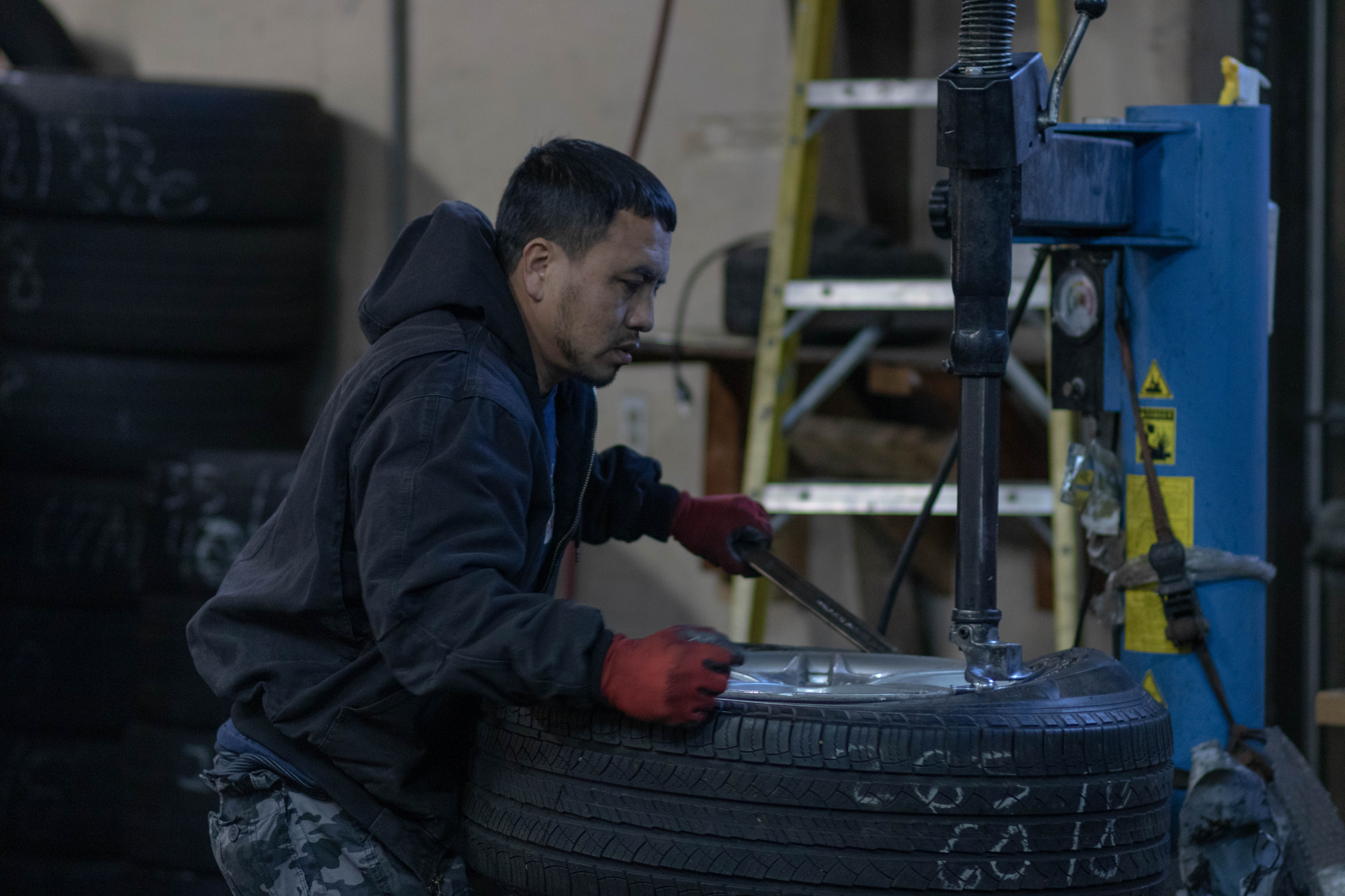 car suv truck getting a tire change New/Used Tires